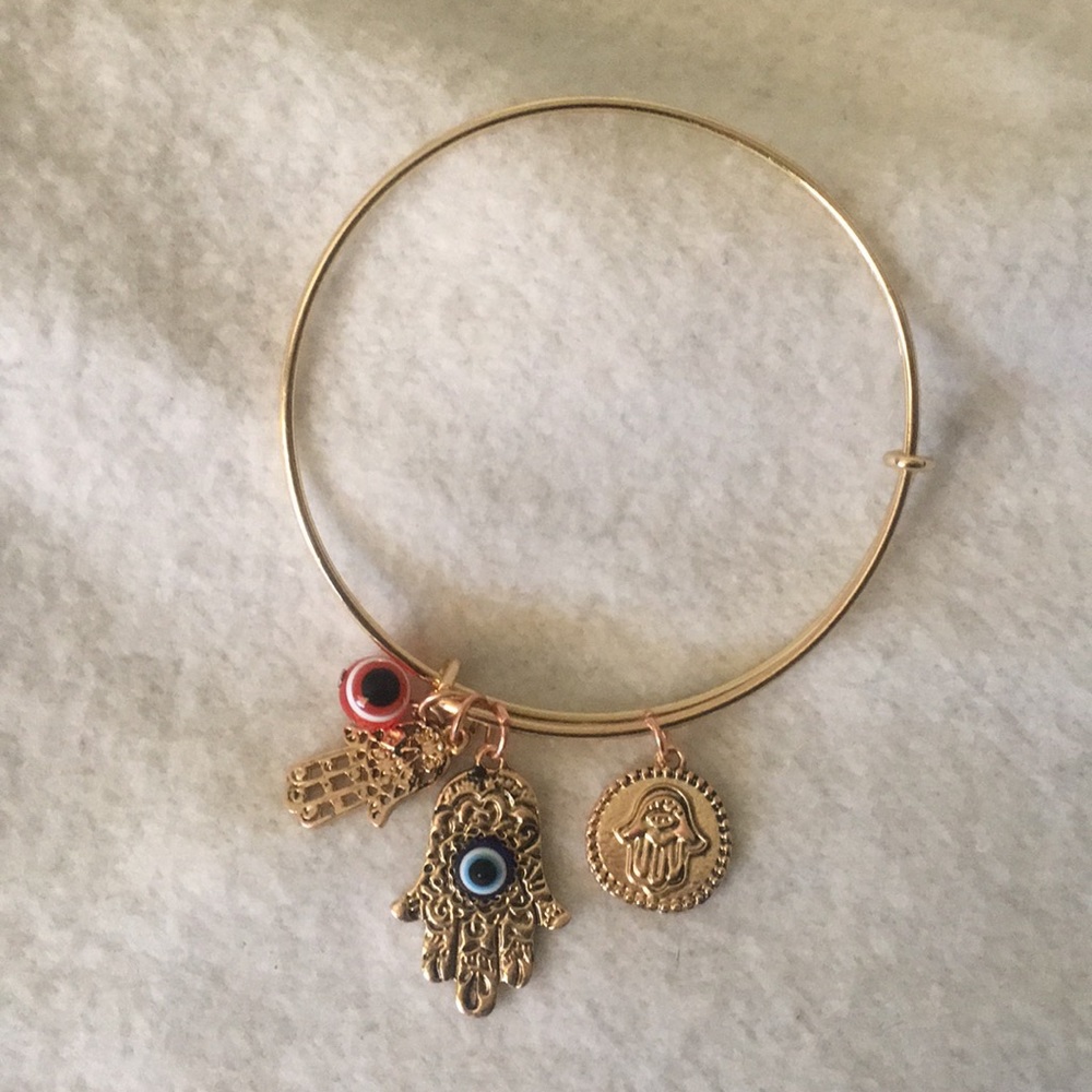Gold tone evil eye hamsa bracelet.